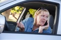 Concerned Woman Using Cell Phone While Driving Royalty Free Stock Photo