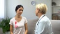 Concerned woman consulting with mammologist, tumor in breast, cancer prevention Royalty Free Stock Photo