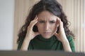 Concerned young italian woman employee looking at computer screen with frustrated face expression Royalty Free Stock Photo