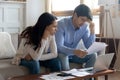 Concerned young married couple studying bank letters informing about debt Royalty Free Stock Photo