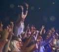 Concert, audience and music with happy woman in group at dj, band and festival event at a stage with lights. Rock show Royalty Free Stock Photo