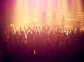 Concert, audience and rock music with hands up from people at dj, band and festival event at a stage with lights. Show Royalty Free Stock Photo