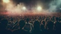 Concert crowd attending a concert, people silhouettes are visible, backlit by stage lights. Raised hands and smart Royalty Free Stock Photo