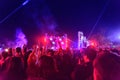 Concert crowd attending a mini concert, people are visible, backlit by stage blue red lights. Royalty Free Stock Photo