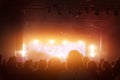 Concert crowd. People silhouettes in front of bright stage lights. Band of rock stars. Royalty Free Stock Photo