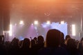 Concert crowd. People silhouettes in front of bright stage lights. Band of rock stars. Royalty Free Stock Photo