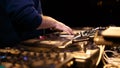 Concert dj scratching vinyl records on turntables in music hall