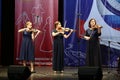 Beautiful women play the violin on stage