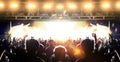 Concert hall with a wide crowd clapping in front of a stage