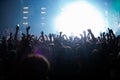 Concert stage lights and crowd on dance floor partying to the music