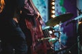 Concert view of a contrabass violoncello player with vocalist and musical during jazz orchestra band performing music,