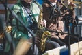 Concert view of a female saxophonist, professional saxophone player with vocalist and musical during jazz band orchestra