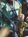 Concert view of a female saxophonist, professional saxophone player with vocalist and musical during jazz band orchestra