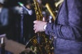 Concert view of a female saxophonist, professional saxophone player with vocalist and musical during jazz band performing music