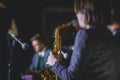 Concert view of a female saxophonist, professional saxophone player with vocalist and musical during jazz band performing music