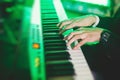 Concert view of a musical keyboard piano player during musical jazz band performing in the background