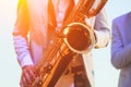 Concert view of saxophonist in a blue and white suit, a saxophone sax player with vocalist and musical band during jazz orchestra Royalty Free Stock Photo