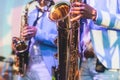 Concert view of saxophonist in a blue and white suit, a saxophone sax player with vocalist and musical band during jazz orchestra Royalty Free Stock Photo