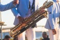 Concert view of saxophonist in a blue and white suit, a saxophone sax player with vocalist and musical band during jazz orchestra Royalty Free Stock Photo