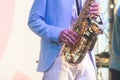 Concert view of saxophonist in a blue and white suit, a saxophone sax player with vocalist and musical band during jazz orchestra Royalty Free Stock Photo