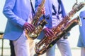 Concert view of saxophonist in a blue and white suit, a saxophone sax player with vocalist and musical band during jazz orchestra Royalty Free Stock Photo