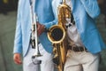 Concert view of saxophonist, a saxophone sax player with vocalist and musical band during jazz orchestra show performing music on