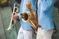 Concert view of saxophonist, a saxophone sax player with vocalist and musical band during jazz orchestra show performing music on