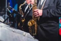 Concert view of a saxophonist, saxophone sax player with vocalist and musical during jazz orchestra performing music on stage Royalty Free Stock Photo