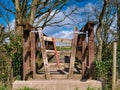 A concertina gate stile on a footbridge on a country walking route. Royalty Free Stock Photo