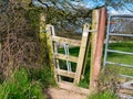 A concertina gate stile between two fields on a country walking route. Royalty Free Stock Photo