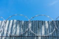 Concertina wire installed atop of metal fence Royalty Free Stock Photo