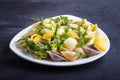 Conchiglie colored pasta with fresh greengrocery on black wooden background