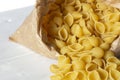 Conchiglie pasta shells in a brown paper bag. Eco-friendly recycling packaging Royalty Free Stock Photo