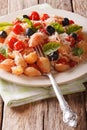 Conchiglie pasta with tomatoes, olives and parmesan cheese close Royalty Free Stock Photo