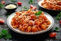 Conchiglie rigate pasta with chickpeas in tomato sauce with parmesan cheese. Healthy vegan food. Royalty Free Stock Photo