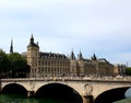 Conciergerie Palace and Bridge of Change over the River Seine, full of visitors on a sunny day Royalty Free Stock Photo