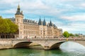 Conciergerie palace with Pont au Change over Seine river in Paris, France. Building of former royal palace and prison Royalty Free Stock Photo