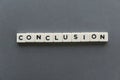 Conclusion word made of square letter word on grey background. Royalty Free Stock Photo