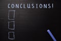 Conclusions! written with color chalk. Supported by an additional services. Blackboard concept Royalty Free Stock Photo