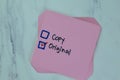 Concpet of Copy or Original write on sticky notes isolated on Wooden Table