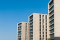 Concrete apartment buildings against blue sky