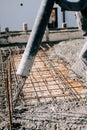 Concrete automatic pump tube working on construction site, Royalty Free Stock Photo