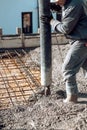 Concrete automatic pump tube working on construction site Royalty Free Stock Photo