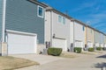 Concrete back alley of residential neighborhood line of two-car garage door colorful houses near Dallas Royalty Free Stock Photo