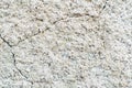 Concrete background. White old cracked stucco wall. Raised abstract texture. Damaged facade of building. Scuffed stone Royalty Free Stock Photo