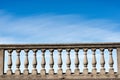 Concrete balustrade on a blue sky with clouds