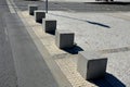 Concrete barriers as protection of a nice lawn cube cubes on a paved sidewalk platform of a tram protected from the entry of cars Royalty Free Stock Photo