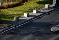 concrete barriers to protect a nice lawn cubes on a paved