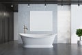 Concrete bathroom, elegant tub and poster Royalty Free Stock Photo