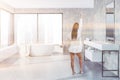 Concrete bathroom interior, tub and sink, woman Royalty Free Stock Photo